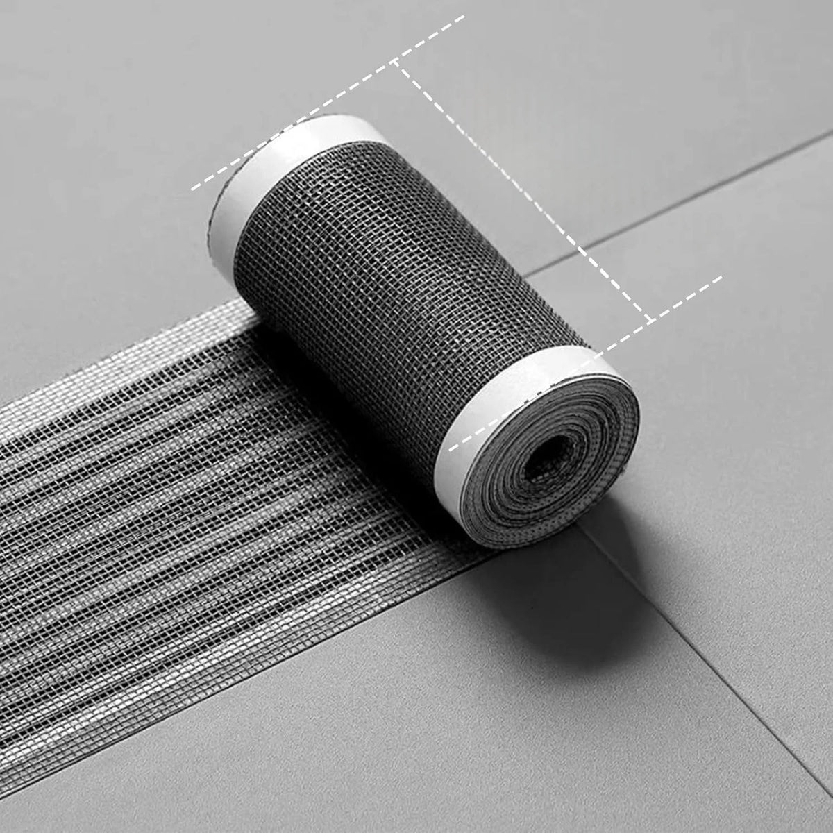 Roll of heavy duty screen repair tape lying on a gray surface.