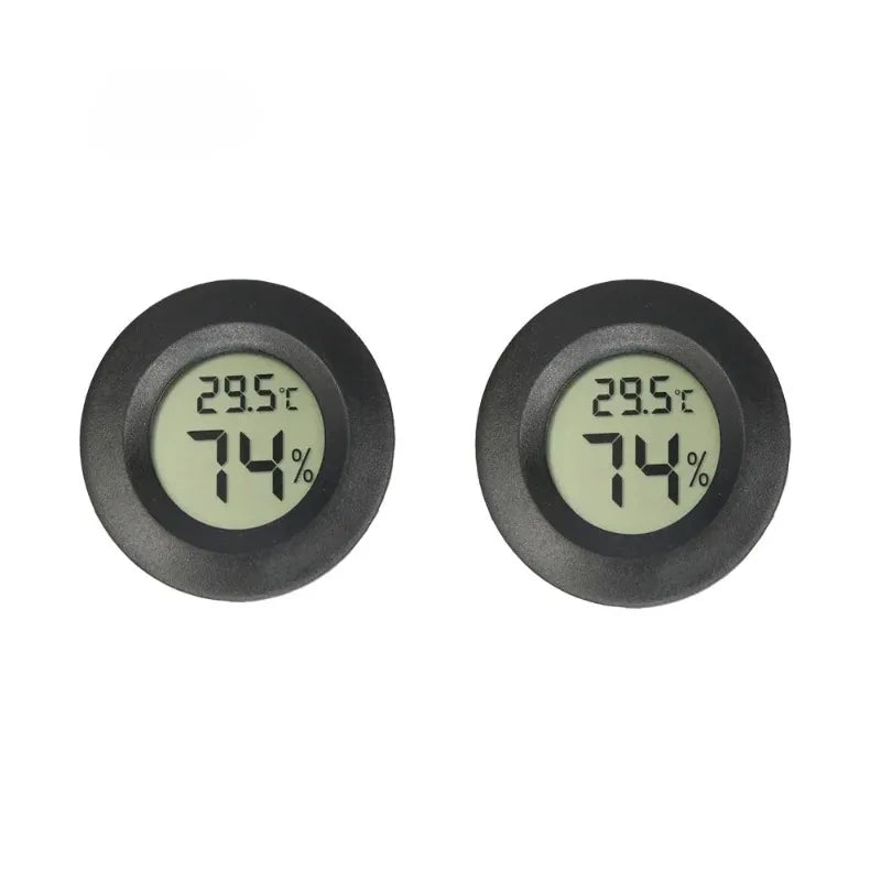 A close-up view of a black digital indoor humidity and temperature meter displaying 29.5°C and 74%.