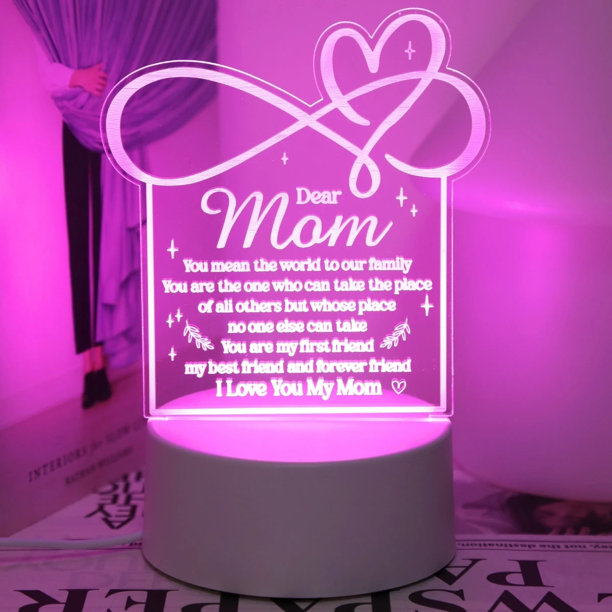 A glowing acrylic sign shaped like a heart with the text Dear Mom and a loving message on it.