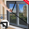 A hand is installing a black self-adhesive window mosquito net onto a window frame.