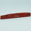 A wooden guitar bone bridge saddle with the inscription Guykör ATR-7630