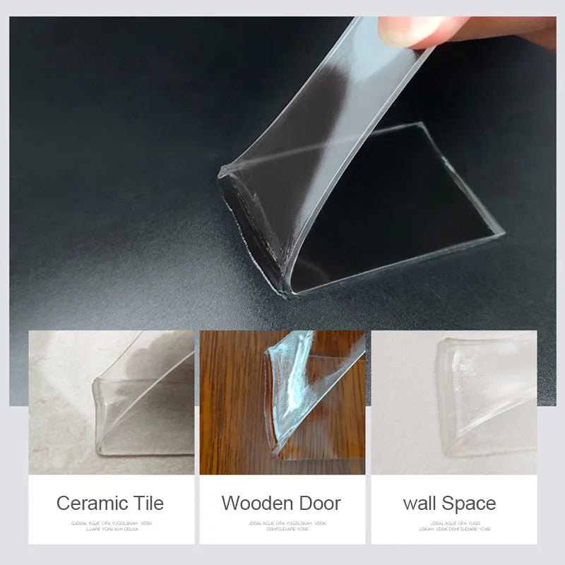 A hand is peeling a piece of clear acrylic tape from a dark surface, showing its thickness and transparency.