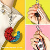 Silver swivel snap hooks with key rings attached to a red and blue crescent moon charm