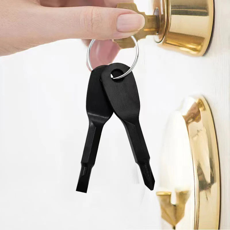 A black 2-piece mini screwdriver set with a keyring is shown hanging from a brass door knob.