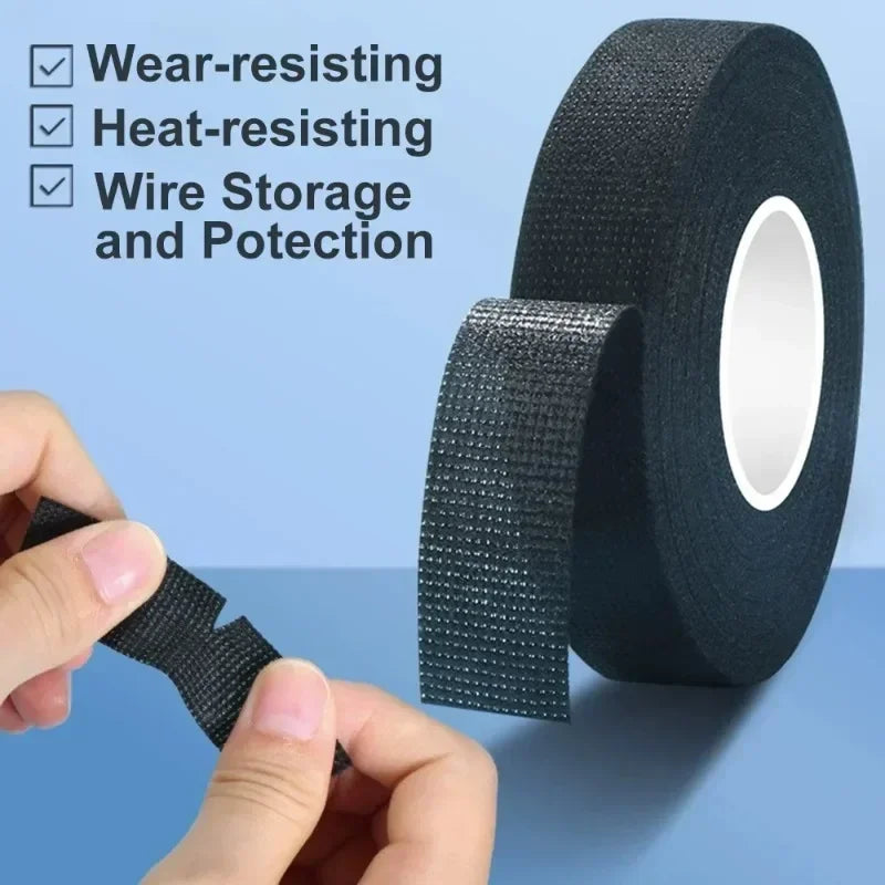 Roll of black wear- and heat-resistant electrical insulating tape being held by a hand