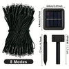 A bundle of black solar powered outdoor LED string lights with individual light heads and a separate light source unit.