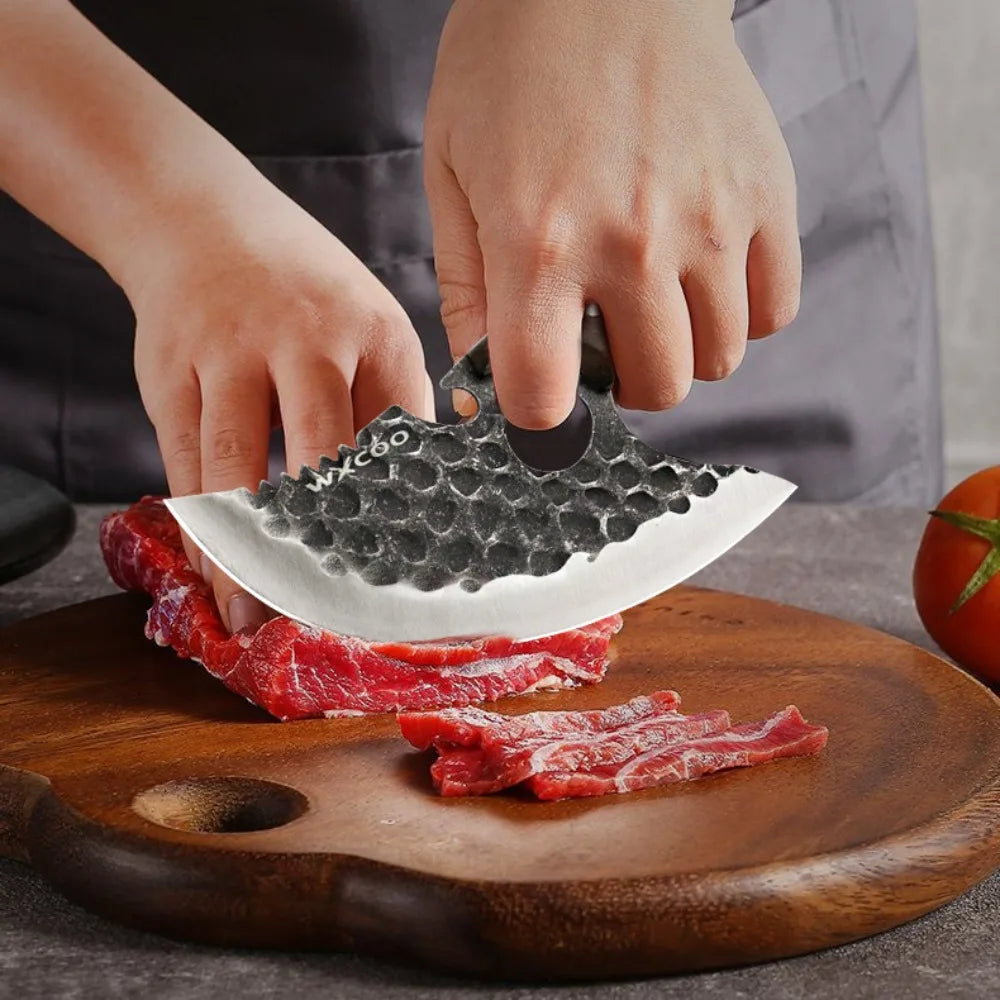 A hand uses a forged stainless steel boning knife with a bottle opener to cut raw red meat on a wooden cutting board.