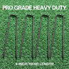 Six 6 inch heavy duty U-shaped garden staples lying on green grass.