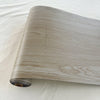 A roll of thickened wood grain self-adhesive wall decals showing light brown and gray wood texture.