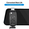 A black car mounted rearview mirror and key holder clip attached to a smartphone.