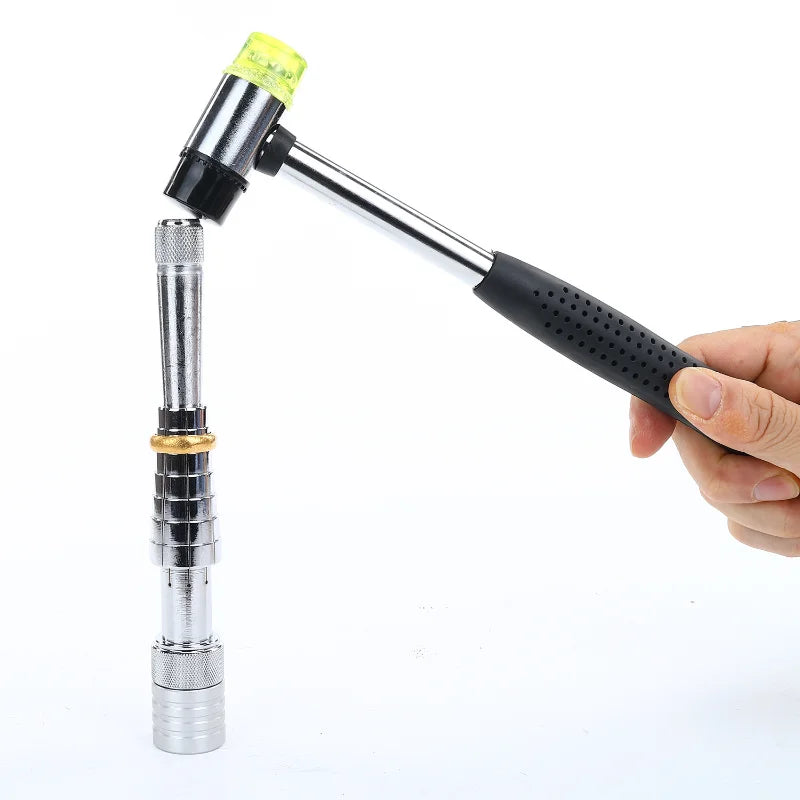 A hand holds a professional ring stretcher and expander tool with a silver body and yellow tip.