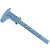A light blue precision plastic vernier caliper measuring tool with a scale marked in both inches and millimeters.