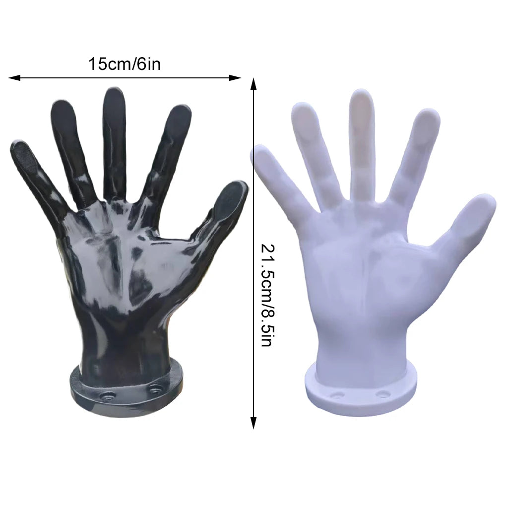 A pair of hand-shaped wall decor, one dark gray and one white, showing the palm print detail.