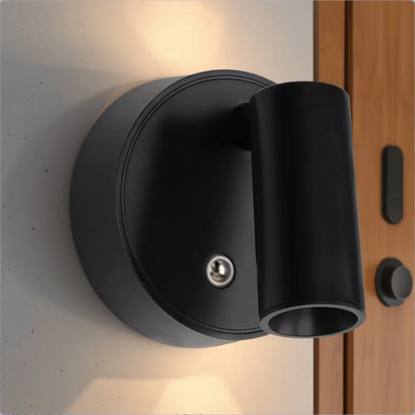 A black touch control LED wall lamp with a magnetic spotlight mounted on a light gray wall.