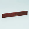 A wooden guitar bone bridge saddle with the text Guyker ATR-8032 engraved on it.