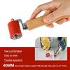 A hand is holding a 40mm silicone seam hand pressure roller flat tool with a wooden handle.
