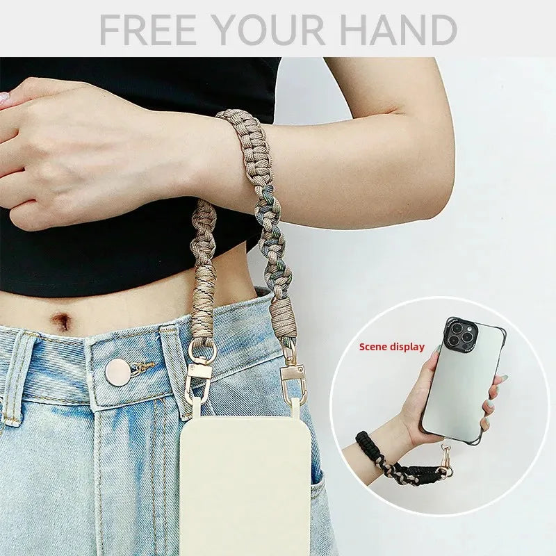 A hand-braided leather lanyard attached to a phone, shown against a person wearing denim jeans.