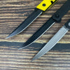 A set of three folding utility knives with black blades and yellow handles resting on a wooden surface.