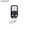 A black universal garage door opener remote replacement with four buttons and a metal split ring.