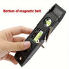 A hand holds the bottom of a magnetic belt, showing screws and a measuring tool.