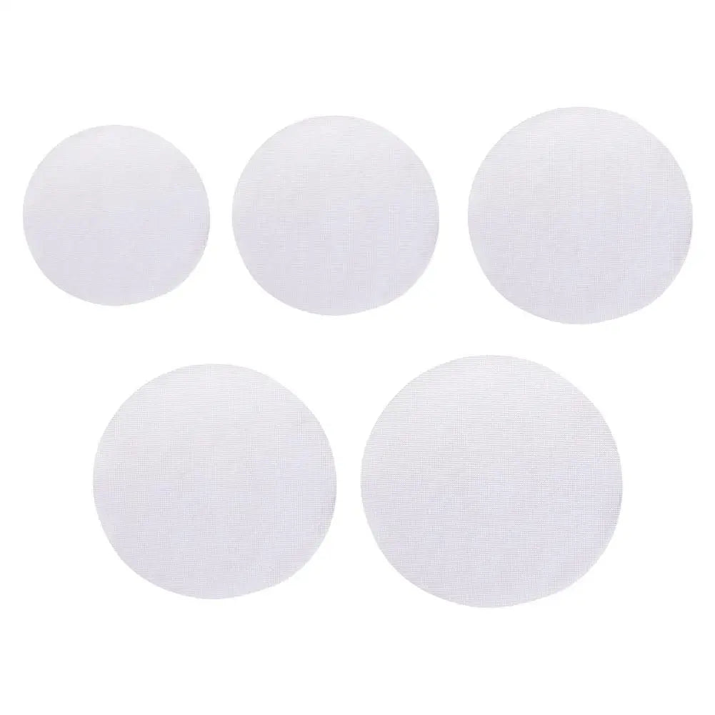 Five white reusable silicone steamer mats of various sizes arranged in a row and a row.