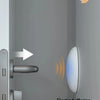 A close-up view of a door with silicone handle bumpers installed to prevent noise and protect the wall.