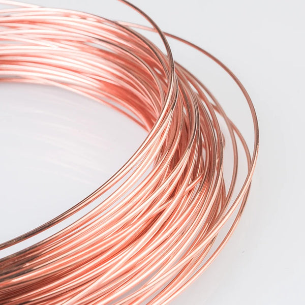 A coil of reddish-copper wire is shown in a curved arrangement against a white background.
