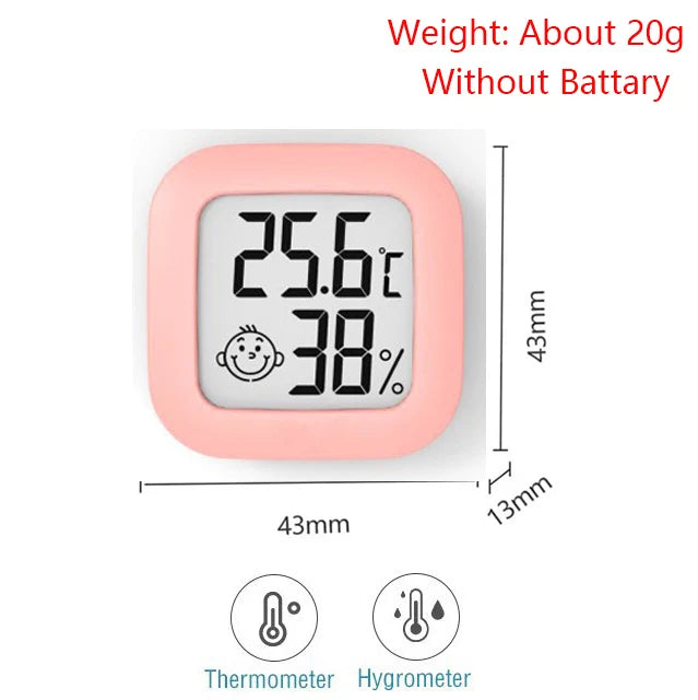 A pink compact digital thermometer and hygrometer displaying 25.6°C and 38% humidity.