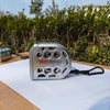 A silver heavy duty retractable metric tape measure with a black strap is placed on a white sheet of paper.