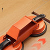 An orange professional floor gap repair tool with suction cups is shown on a light wood floor.
