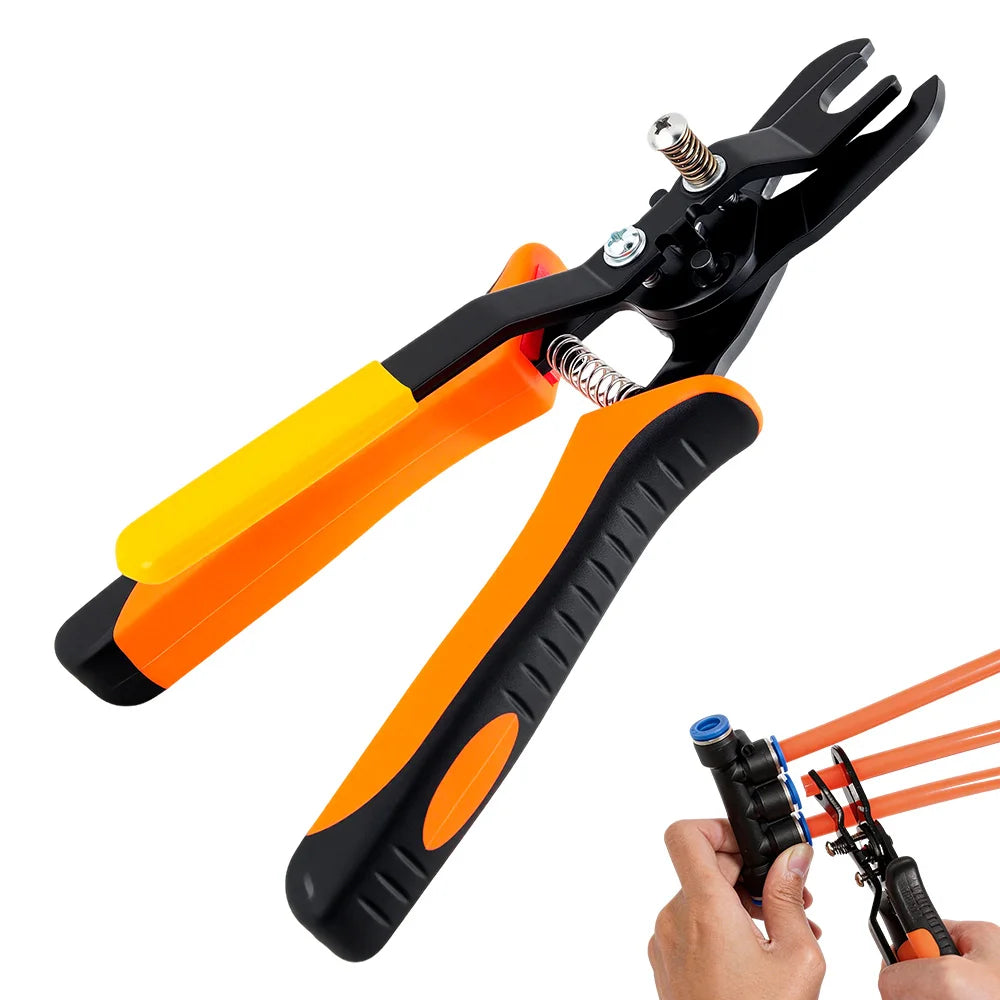 A hand is holding a black pneumatic disconnect tool set with orange and yellow handles.