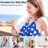 A woman is using a portable mist fan outdoors, shopping, traveling, and in an office setting.