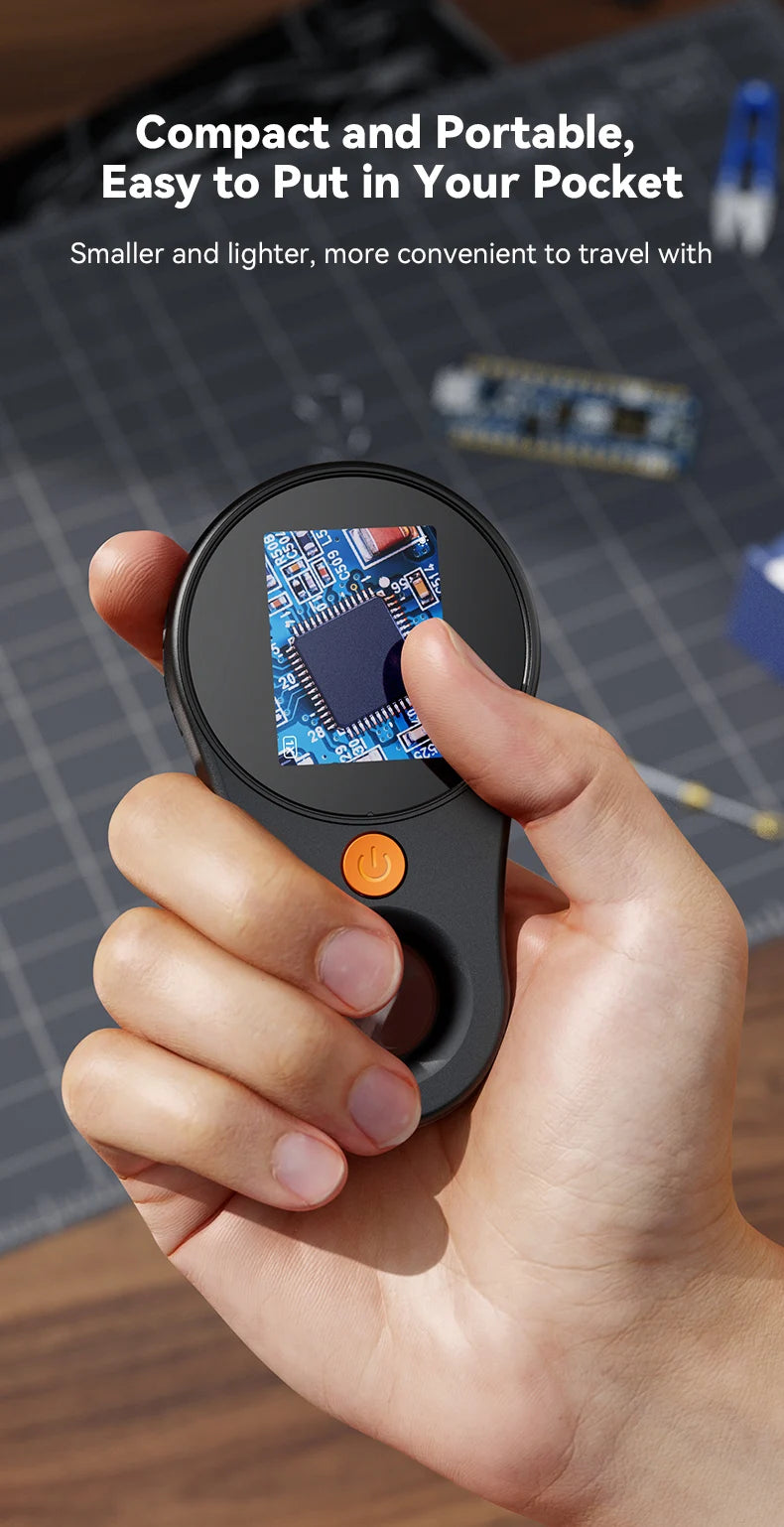 A hand holds a compact digital handheld microscope with an LED light, showing a circuit board under magnification.