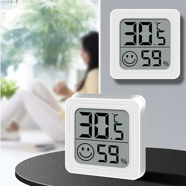 A white digital thermometer and hygrometer displaying 30.5 degrees Celsius and 59 percent humidity.