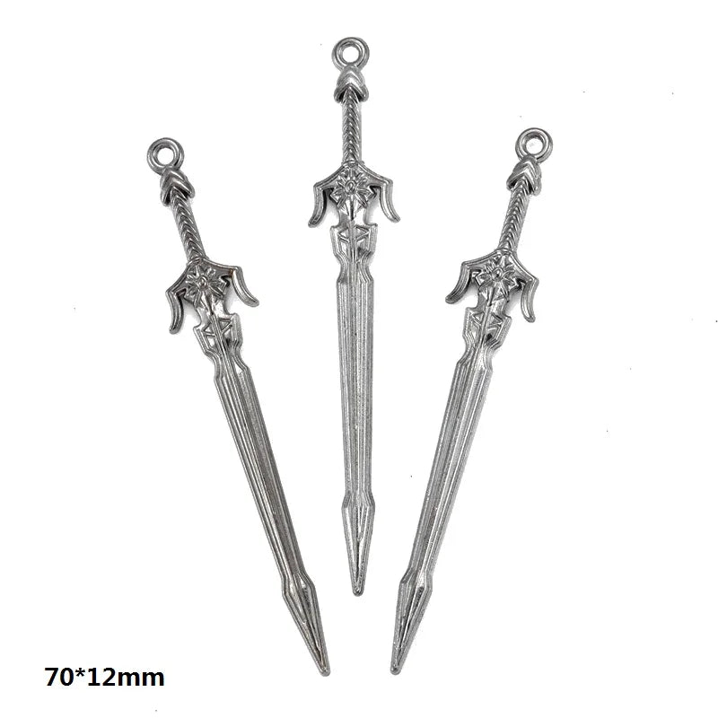 Three silver-toned alloy charms or pendants of varying styles and sizes for DIY jewelry making