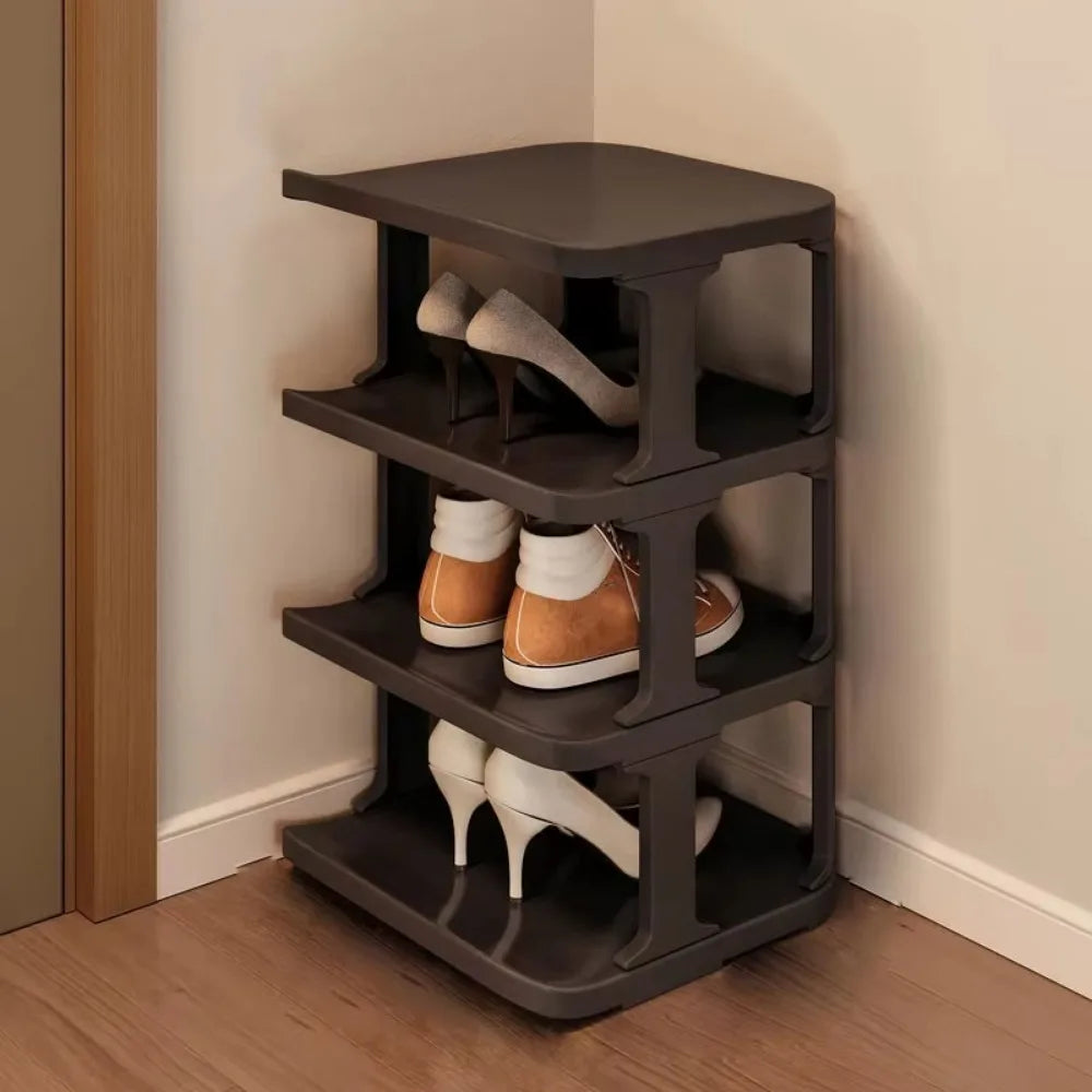 A dark gray stackable vertical shoe rack organizer holding various pairs of shoes.