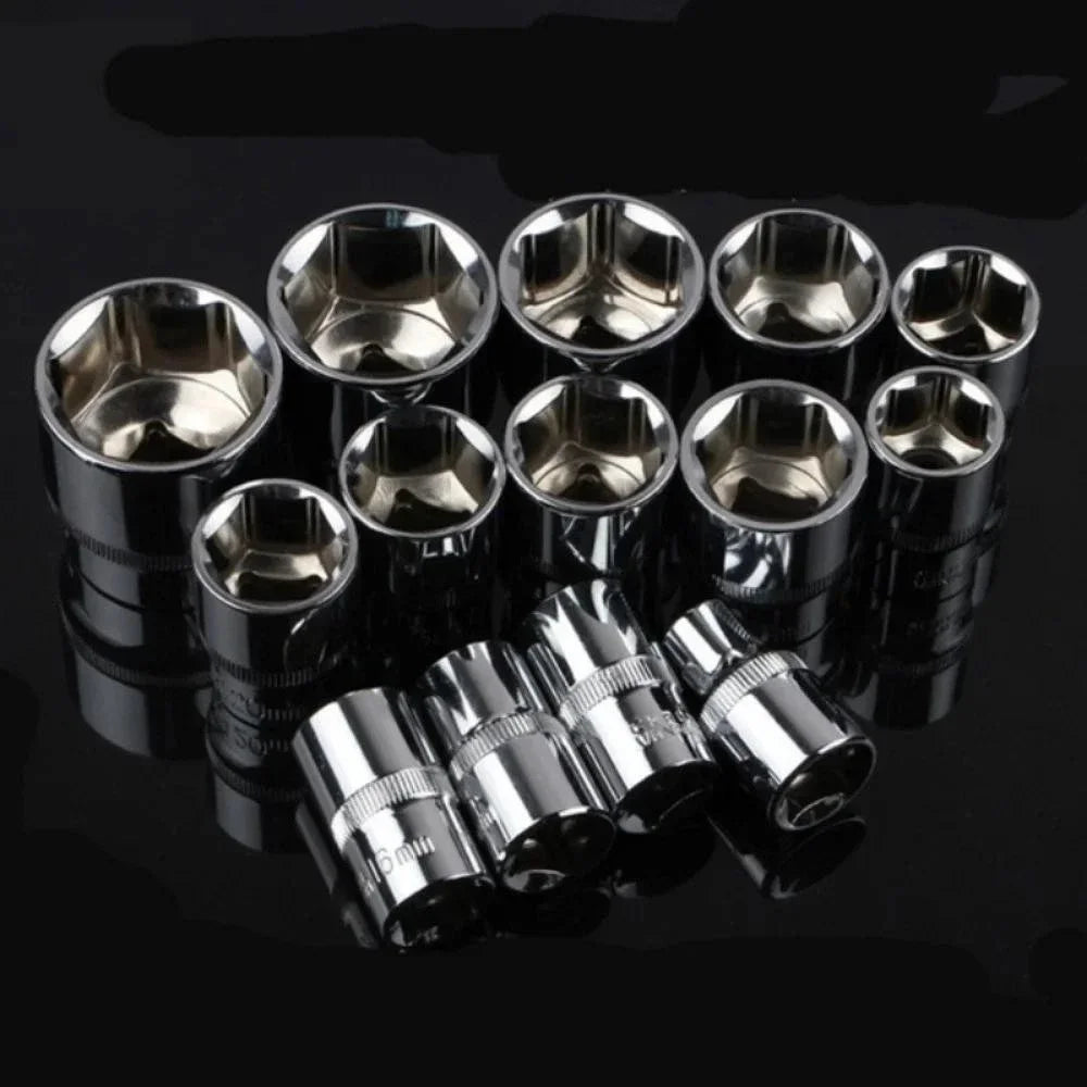 A set of twelve shiny metal wrenches and sockets arranged in a row on a dark surface.
