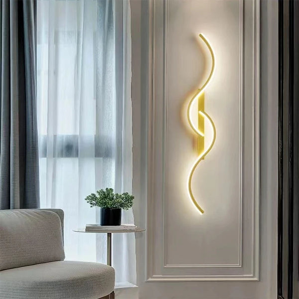 Modern LED wall sconce with a curved yellow light illuminates a white wall in a bright room.