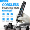A hand holds a black cordless soldering iron with a tip, positioned over an electronic circuit board.