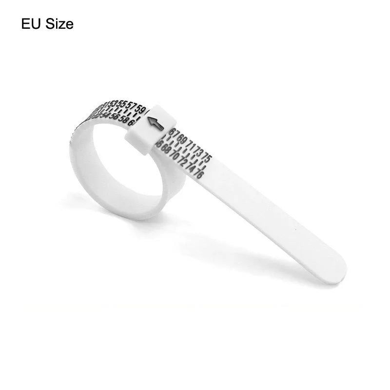 A white plastic ring sizer with various size markings is shown on a white background.