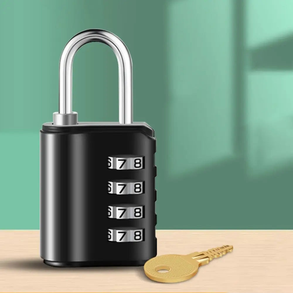 A black heavy duty combination lock with a silver shackle and a brass key is shown on a wooden surface.