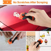 A hand uses an orange dual-purpose razor scraper to remove scratches from a red car surface.