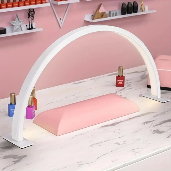 A white dimmable arc beauty lamp illuminates a pink cushion on a marble countertop.