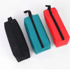 Three hand-held storage bags in black, teal, and red with zippers shown side by side.