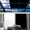 Black opaque self-adhesive window film installed in a modern window frame with natural light and sky view.