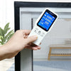 A hand holds a digital electronic device with a screen displaying 0.000 and buttons, positioned in front of a window frame.