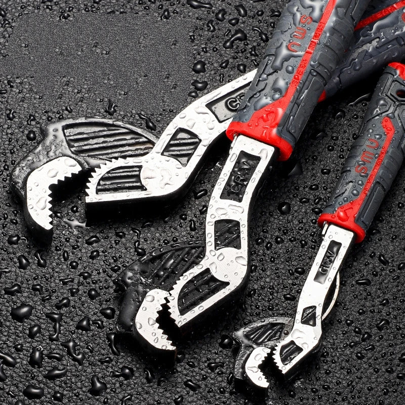 A set of adjustable multi-sized locking wrenches with black and red handles resting on a dark, wet surface.