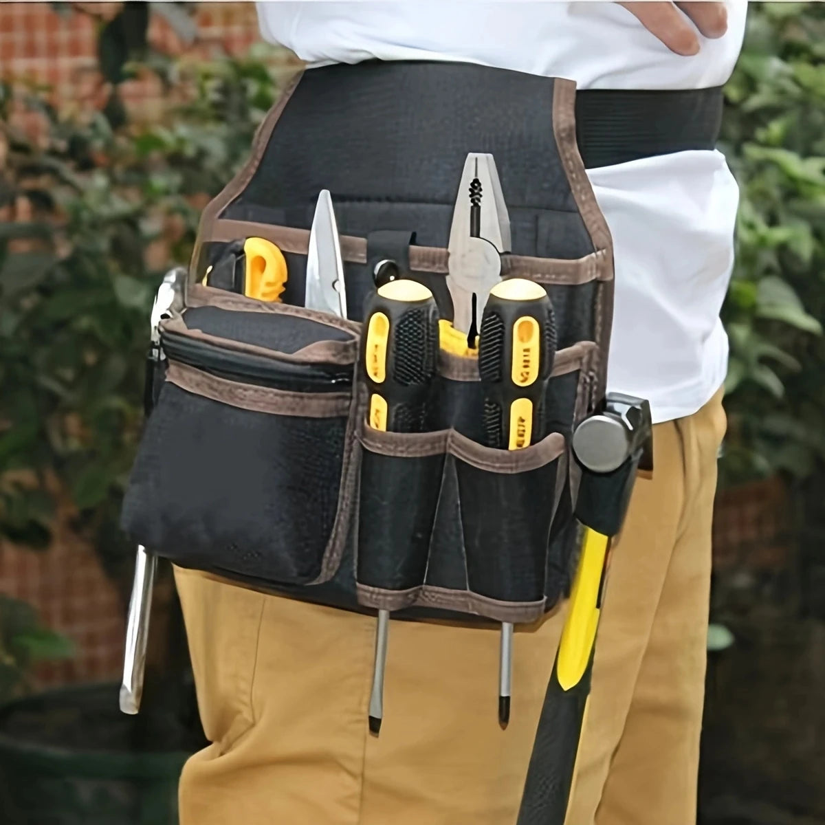 A black tool storage belt bag with multiple knife and tool slots worn by a person.