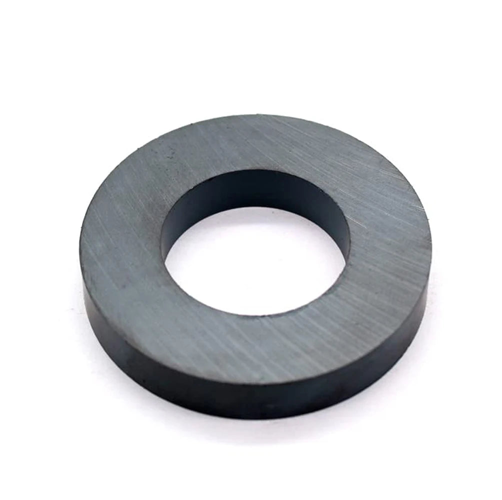 A black industrial ceramic ring magnet with a smooth, circular shape.