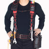 Person in black shirt and pants with a heavy-duty tool belt and suspenders